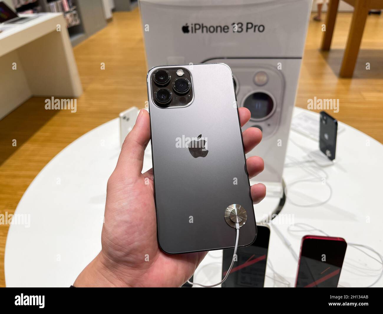 Bangkok, Thailand - October 13, 2021: Hands on iPhone 13 series are shown to sell in iStudio By Comseven - EMQUARTIER DEPARTMENTSTORE in Bangkok, Thai Stock Photo