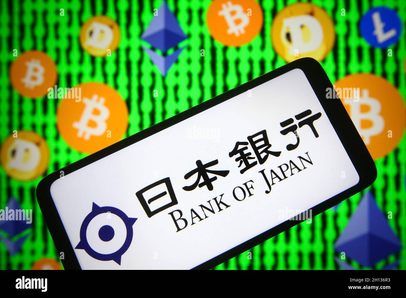 Ukraine. 15th Oct, 2021. In this photo illustration, Bank of Japan (BOJ)  logo is seen on a smartphone screen and Bitcoin, Ethereum, Litecoin and  Dogecoin cryptocurrencies logos in the background. Bank of