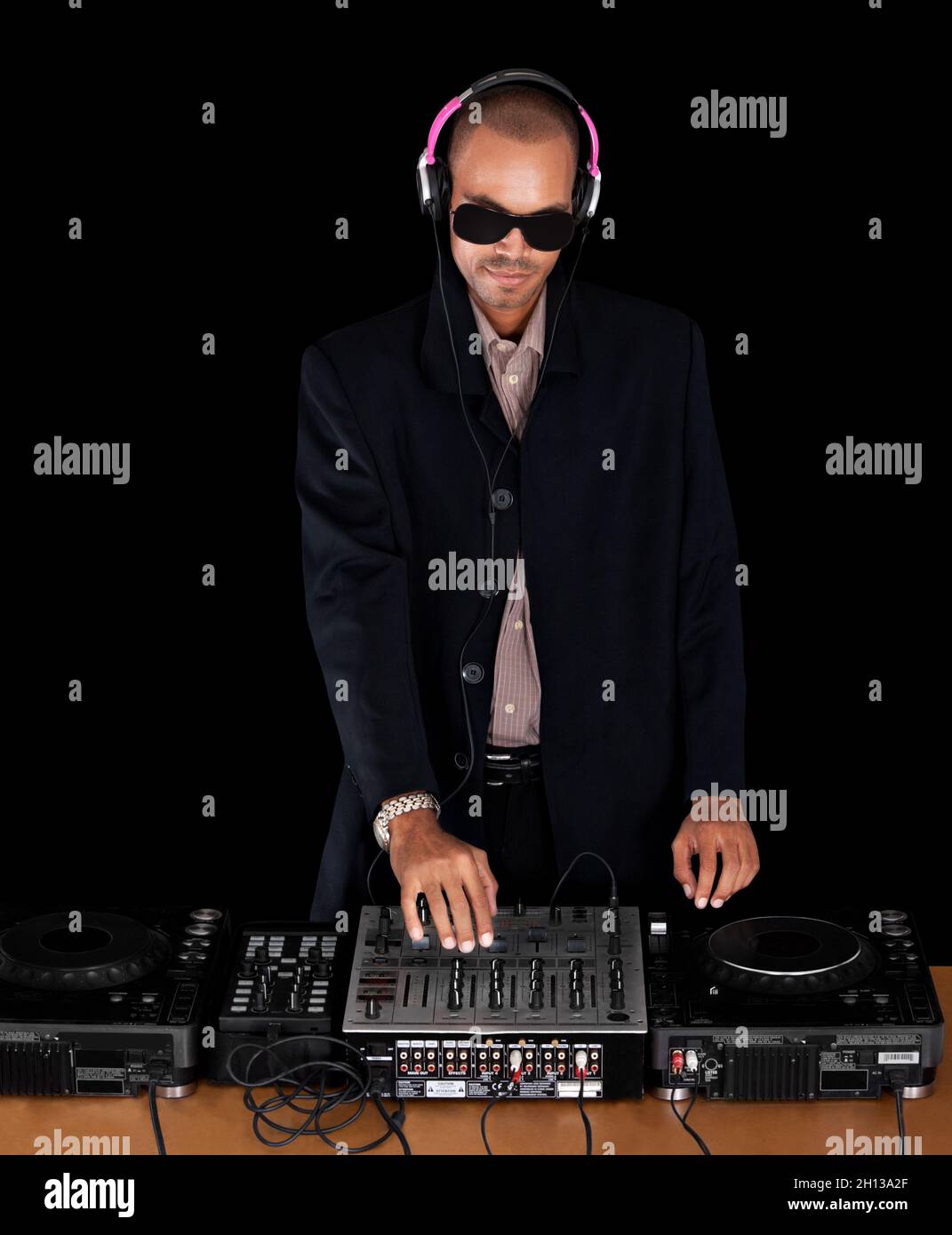 African musician singer turning knobs at the turntable of a  DJ music system Stock Photo