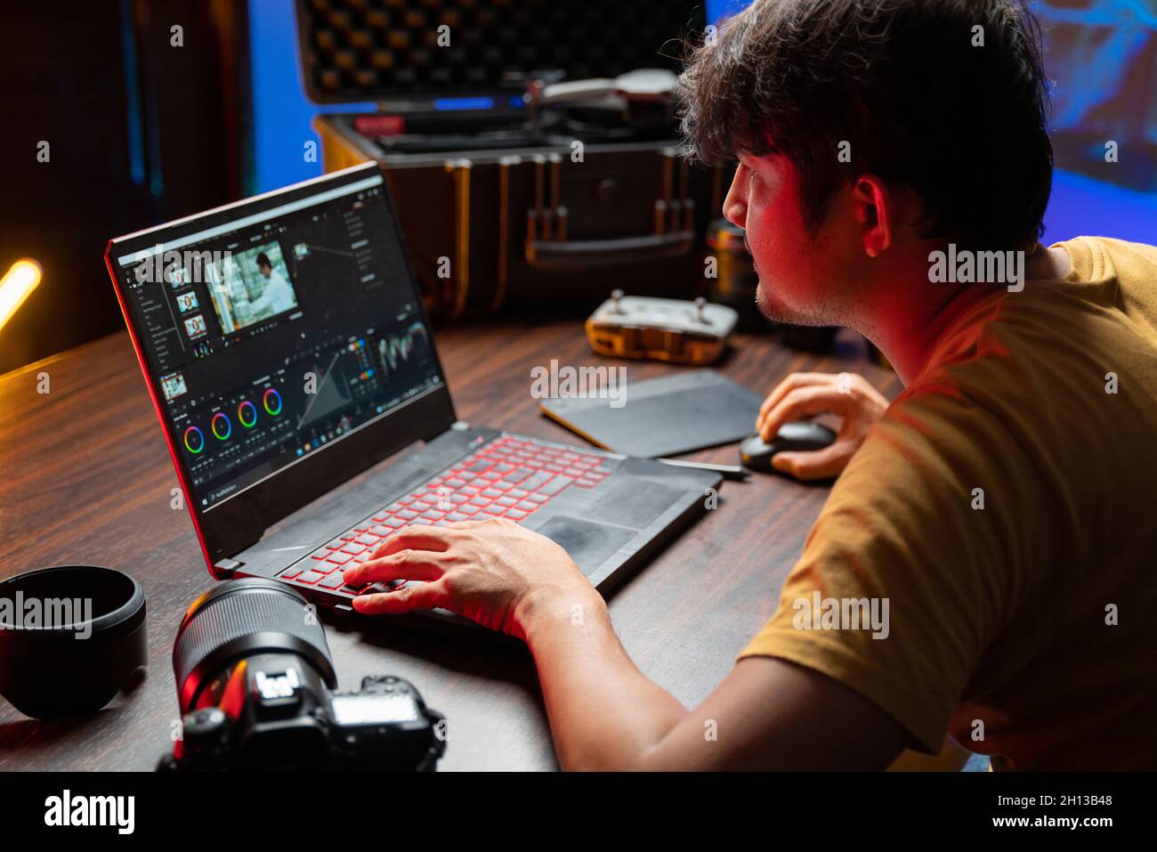 A man video editor works with footage on his personal computer, he works in creative office studio. Film making. Equipment filmmaking. Create videos. Stock Photo