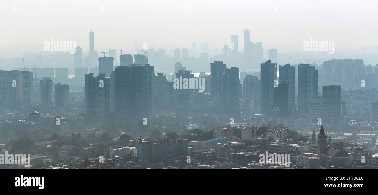 Large panoramic picture of Seoul with skyscrapers construction in the morning. Air pollution, bad ecologia over Seoul in South Korea. Stock Photo