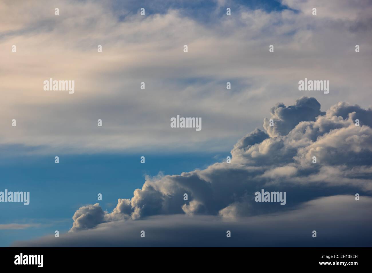 Cumulus clouds against a blue sky Stock Photo - Alamy