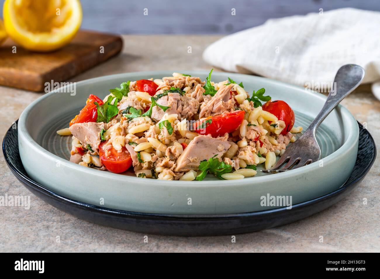 Tuna and orzo pasta with cherry tomatoes and parsley Stock Photo Alamy