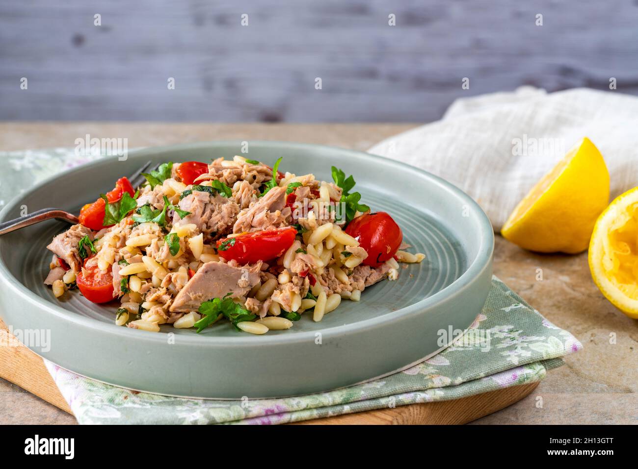 Tuna and orzo pasta with cherry tomatoes and parsley Stock Photo Alamy