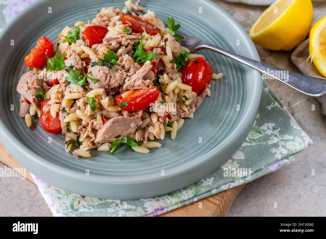 Tuna and orzo pasta with cherry tomatoes and parsley Stock Photo Alamy