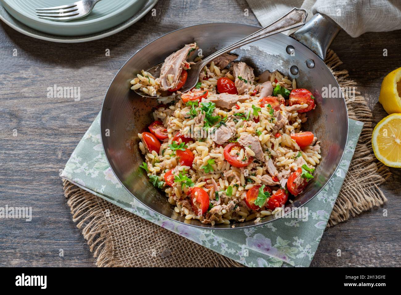 Tuna and orzo pasta with cherry tomatoes and parsley Stock Photo Alamy