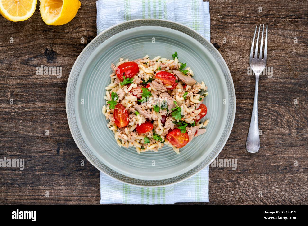 Tuna and orzo pasta with cherry tomatoes and parsley Stock Photo Alamy