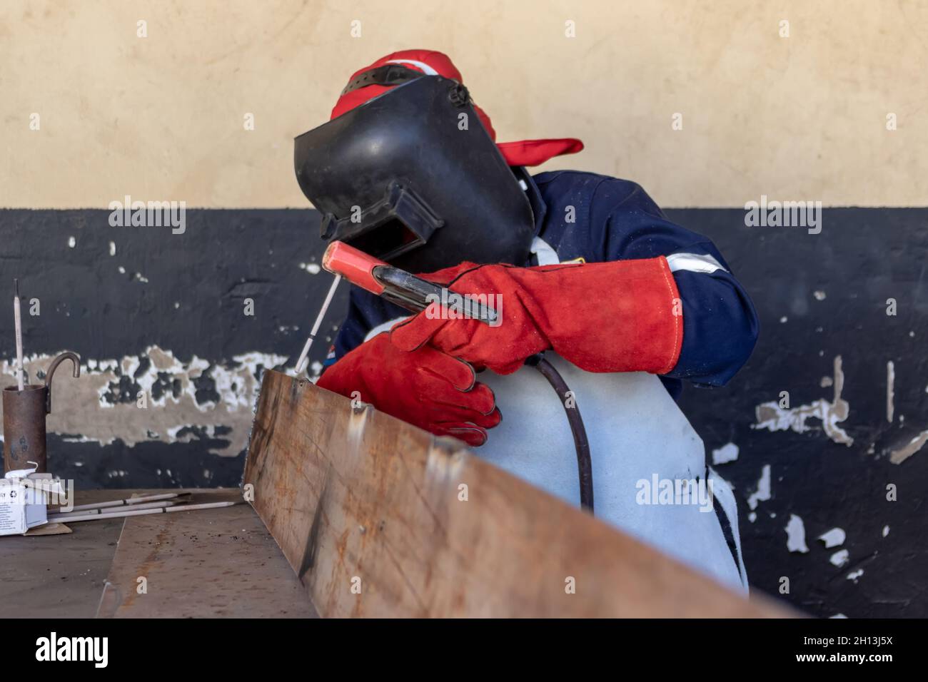 Motswana Welder Worker In A Botswana Workshop Welding Two Pieces Of motswana-welder-worker-in-a-botswana-workshop-welding-two-pieces-of
