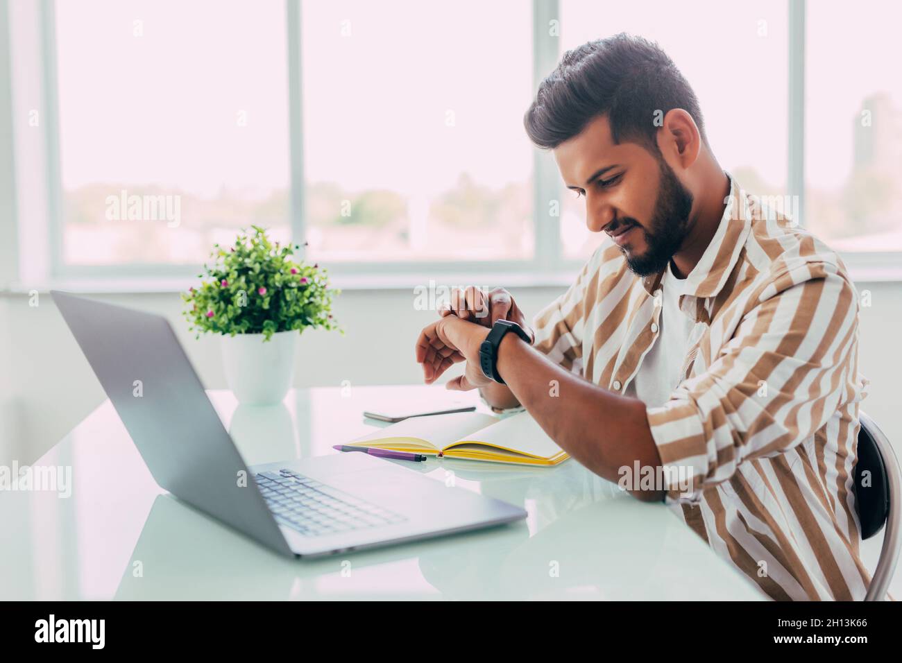 business man looking at his watch in office Stock Photo
