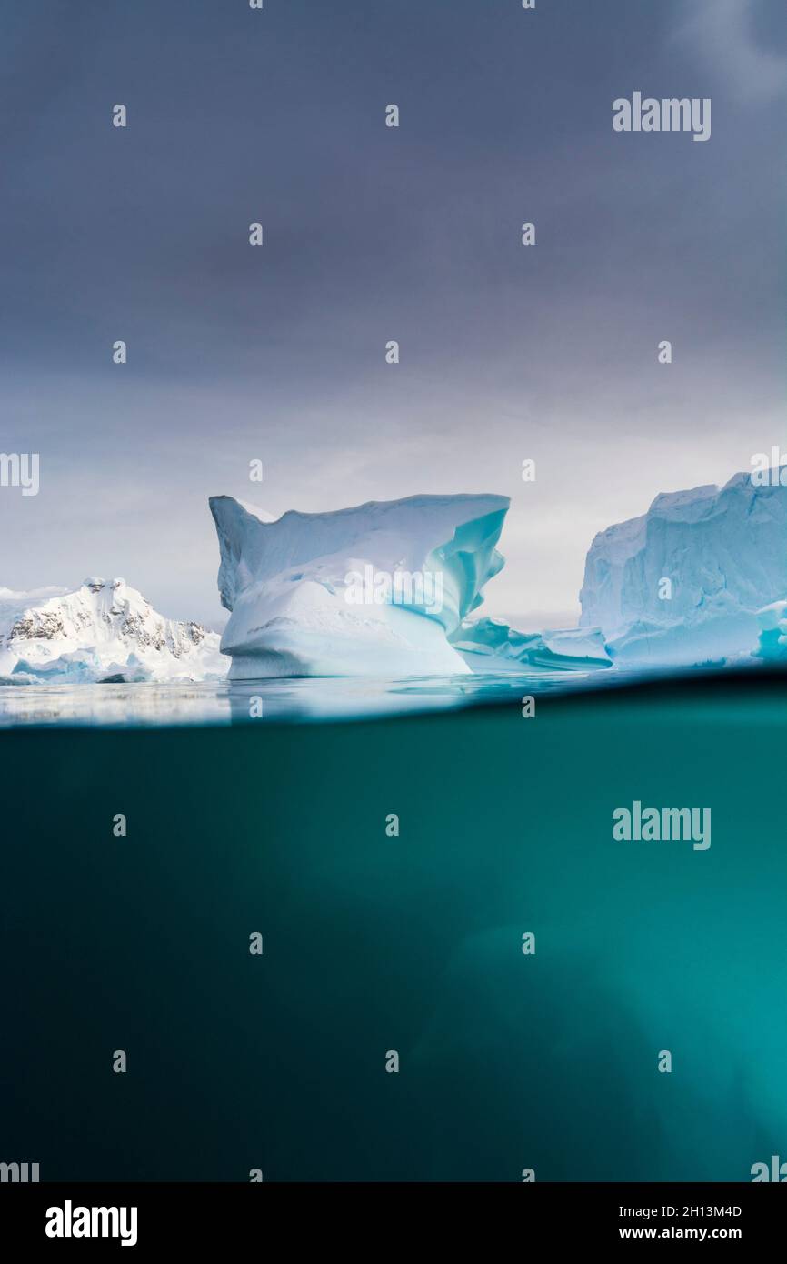 Over-under view of an iceberg, Skontorp cove, Paradise Bay, Antarctica. Antarctica. Stock Photo