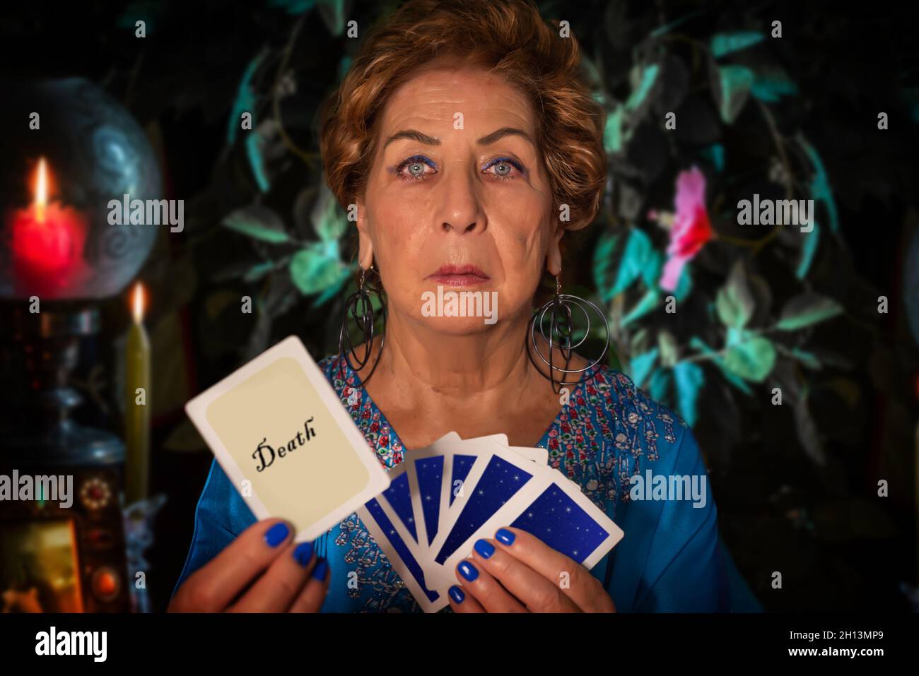 A fortune teller shows the tarot card of death. Witch showing the image of death Stock Photo