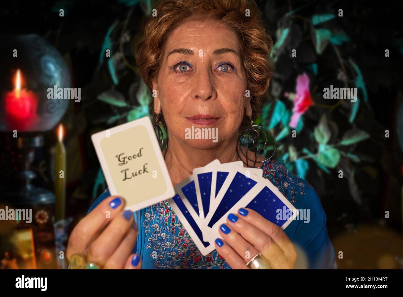 Gypsy Pythoness shows a good luck tarot card. Medium takes a card with her hands Stock Photo