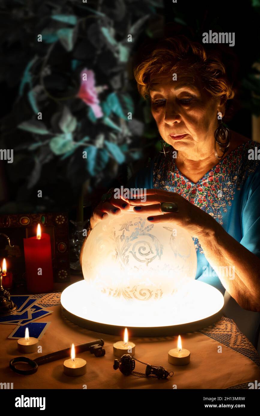 Pythoness reading the future in a crystal ball Stock Photo - Alamy