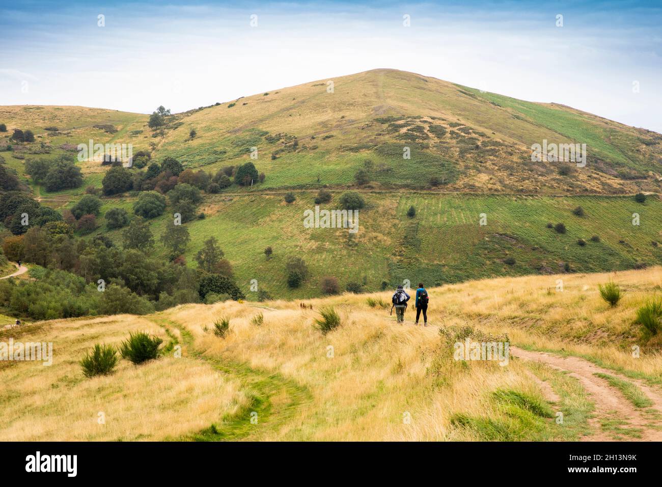 UK, England, Worcestershire, Malvern Hills, walkers on footpath descending from Worcestershire Beacon to Malvern Stock Photo
