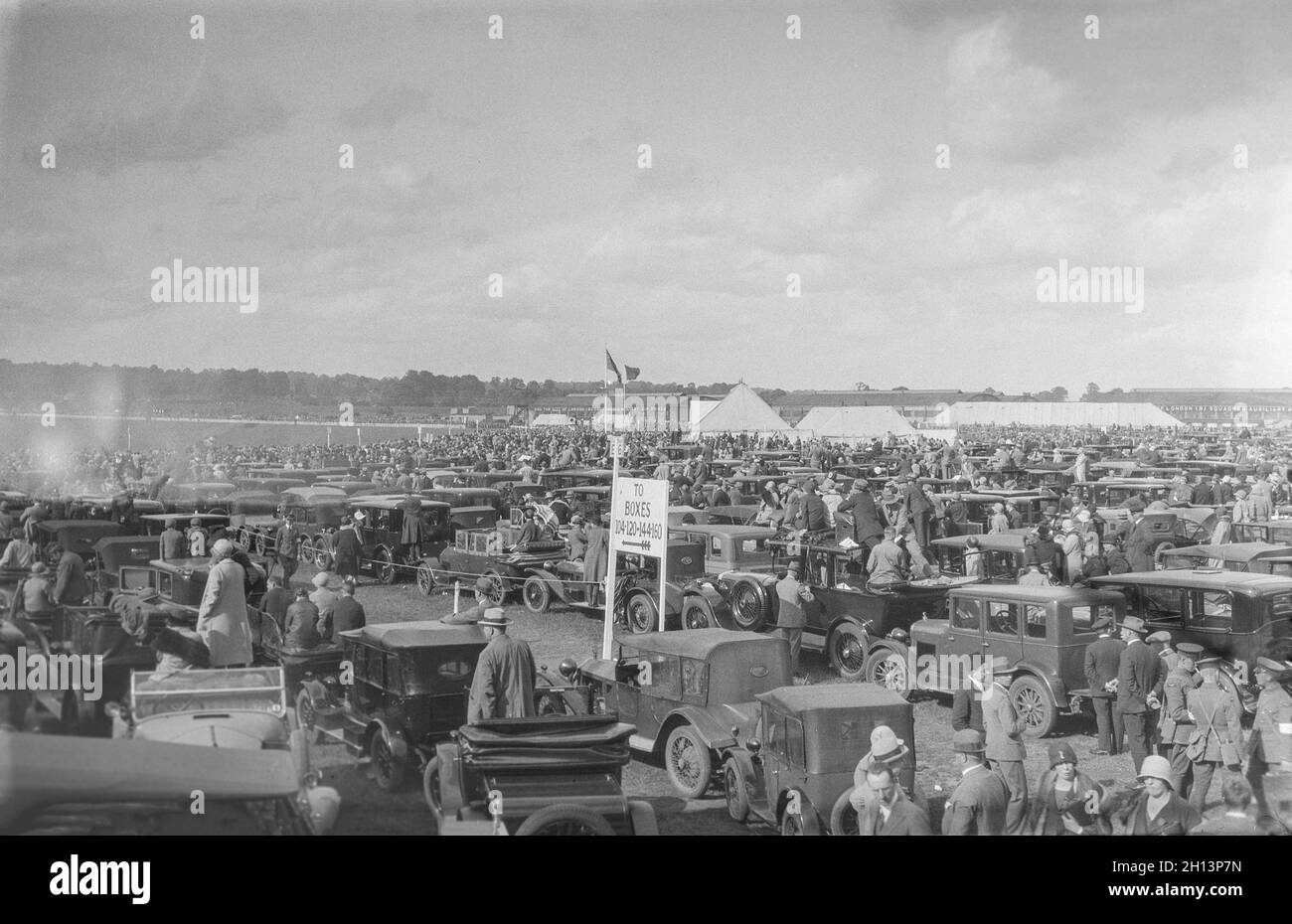 A vintage 1925 black and white photograph showing an air display at RAF Northolt near London, England. A large crowd watches the display. Stock Photo