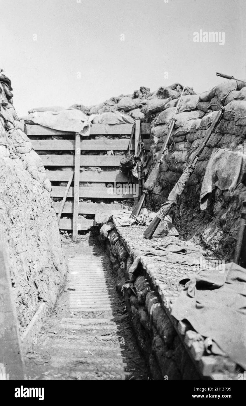 A vintage photograph taken in 1917 showing a British Forces trench at Maple Copse near Ypres during the First World War. Rifles are leant up against the trench wall, one with bayonet fitted. Stock Photo