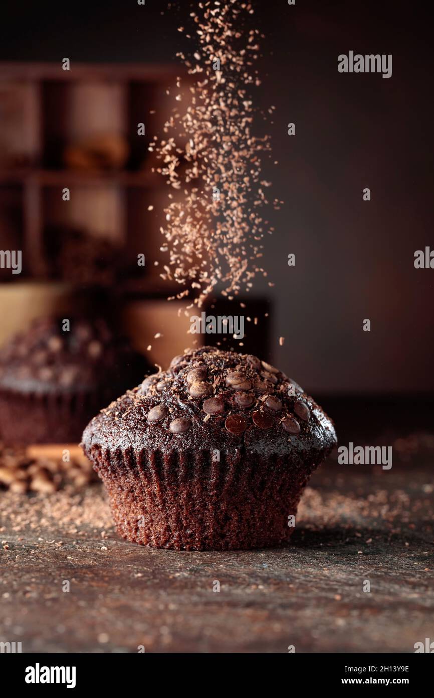 Delicious fresh chocolate muffins on a brown background Stock Photo - Alamy