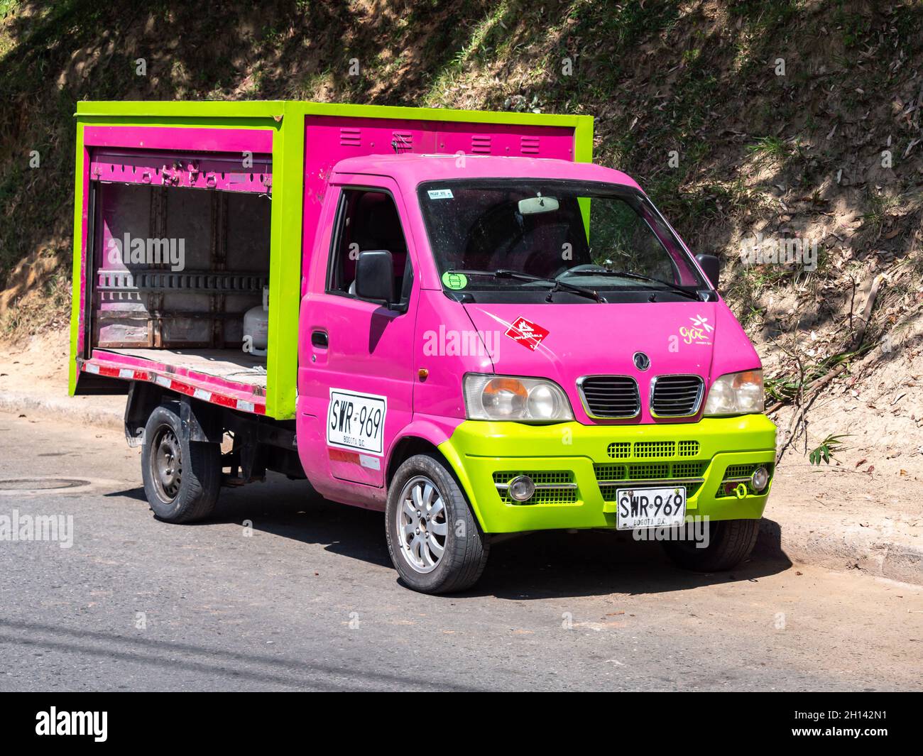 Medellín, Antioquia, Colombia - December 23 2020: Small Pink and Green Pickup Truck, it is Open to Store Things Stock Photo
