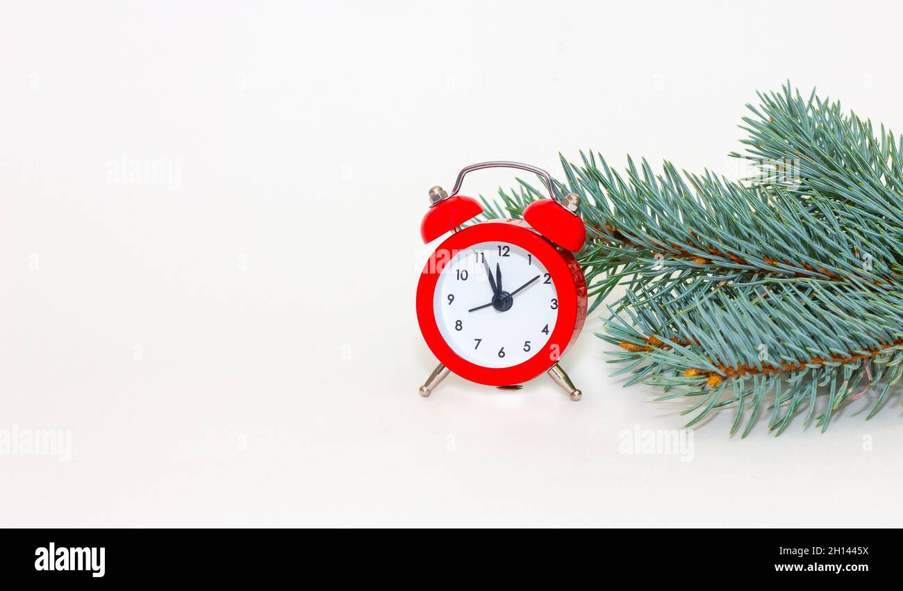 Retro with red alarm clock and fir branches for concept design. Christmas and New Year Stock Photo