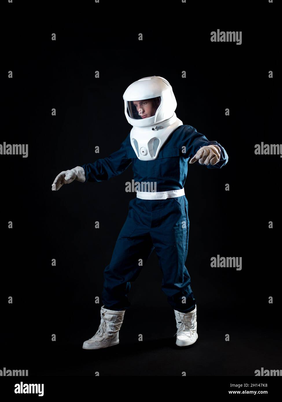 The astronaut is floating in weightlessness. The hero of the science fiction story is a pioneer of space exploration. A young man in a space suit Stock Photo
