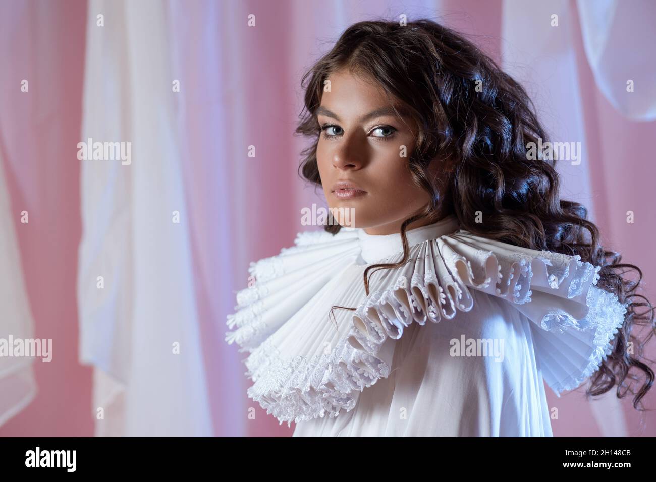 glamorous portrait of noble lady in white blouse and medieval round collar around her neck. young beautiful brunette in medieval costume, a portrait i Stock Photo