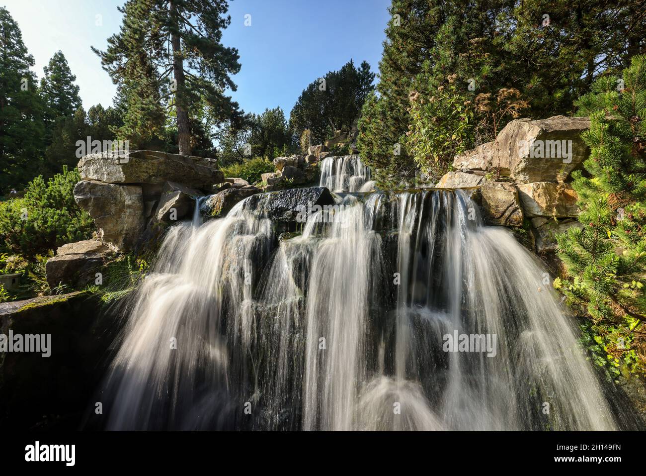 Essen, North Rhine-Westphalia, Germany - Alpinum with waterfall, Grugapark, a park in Essen, has arisen from the first Great Ruhrlaendische Horticultu Stock Photo