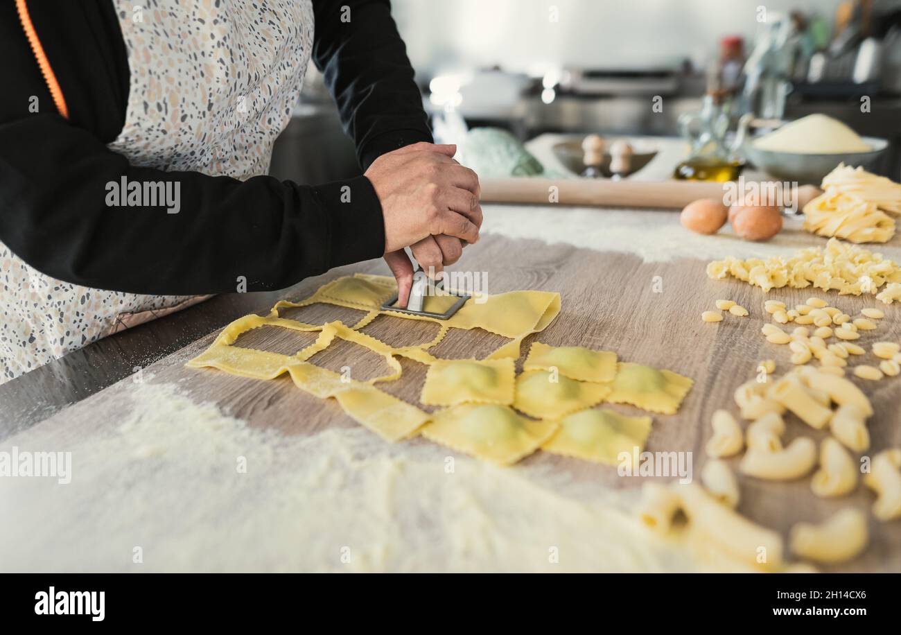 Close up female hands preparing fresh homemade ravioli pasta Stock Photo