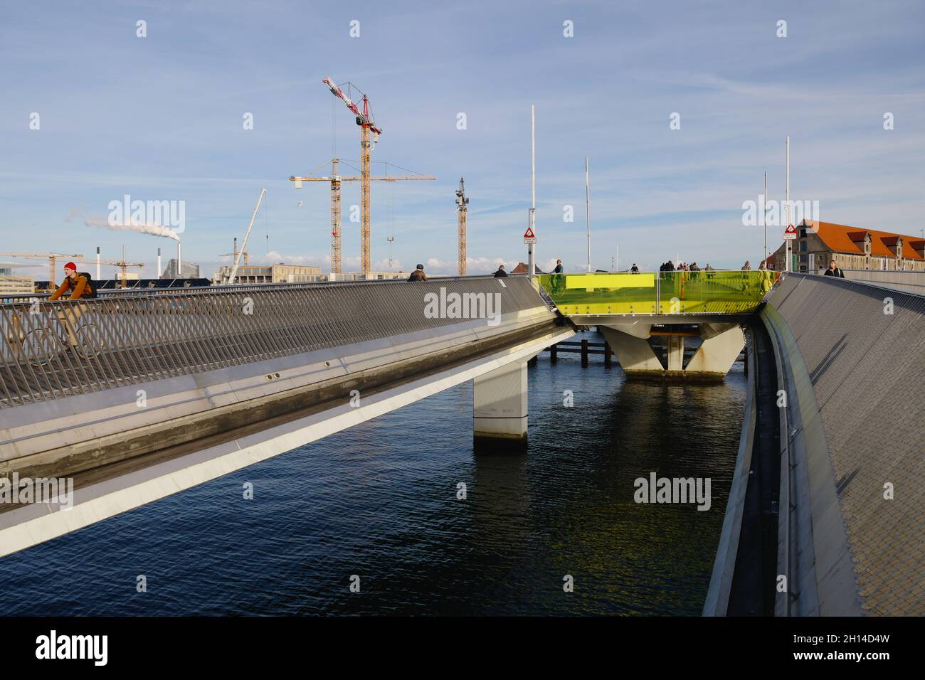 Cyclists cross Inderhavnsbroen (The Inner Harbour Bridge), completed 2016, Copenhagen, Denmark, Scandinavia, October 2021 Stock Photo
