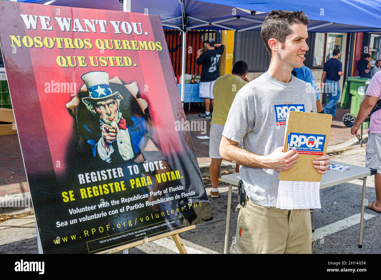 Miami Florida,Little Havana,Hispanic bilingual voter registration drive registering voters,man male Republican Party volunteer worker Uncle Sam poster Stock Photo