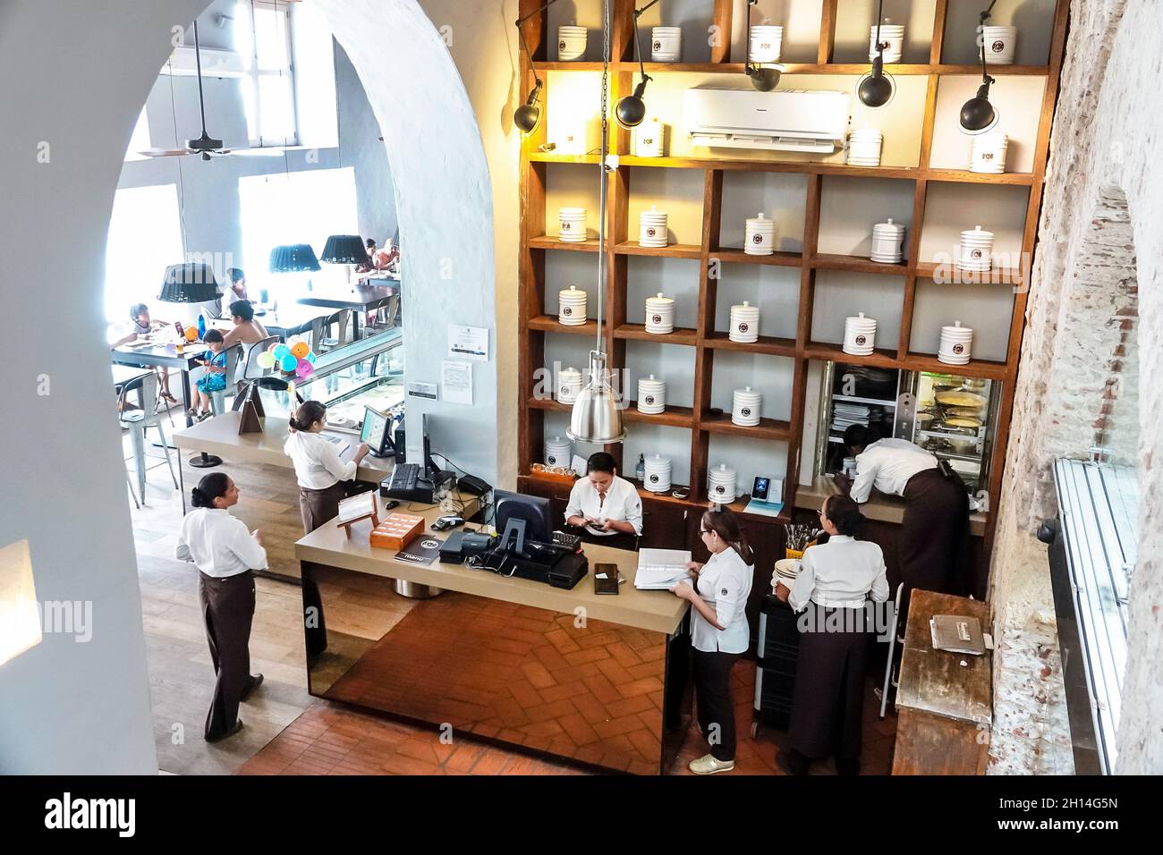 Cartagena Colombia,Crepes & Waffles,restaurant inside interior cashier,Hispanic female women servers employees staff overhead view from above Stock Photo