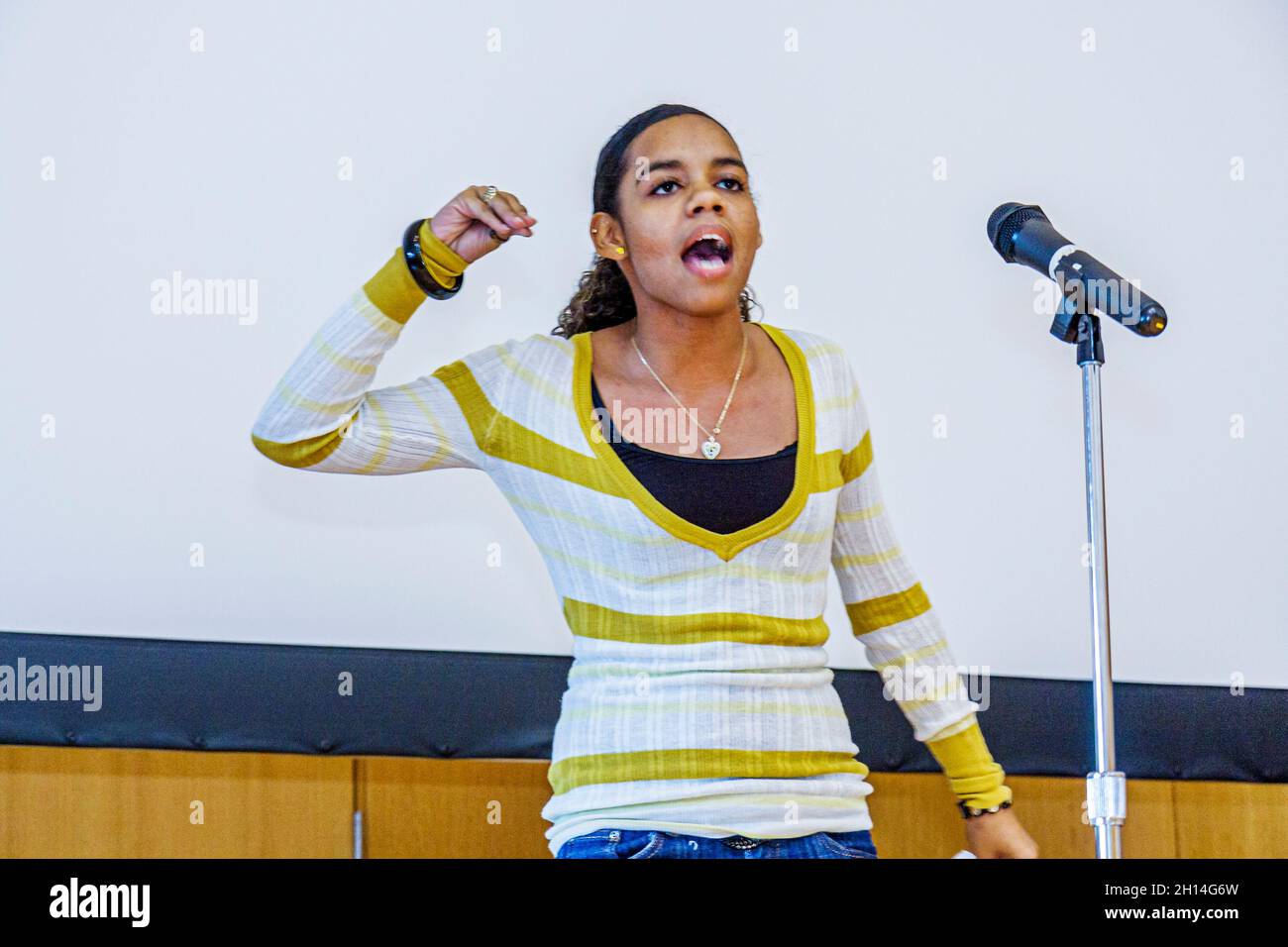 Miami Beach Florida,Main Public Library,Youth Poetry Slam,performance presentation,urban art form poet,Black teen girl stage microphone speaking Stock Photo