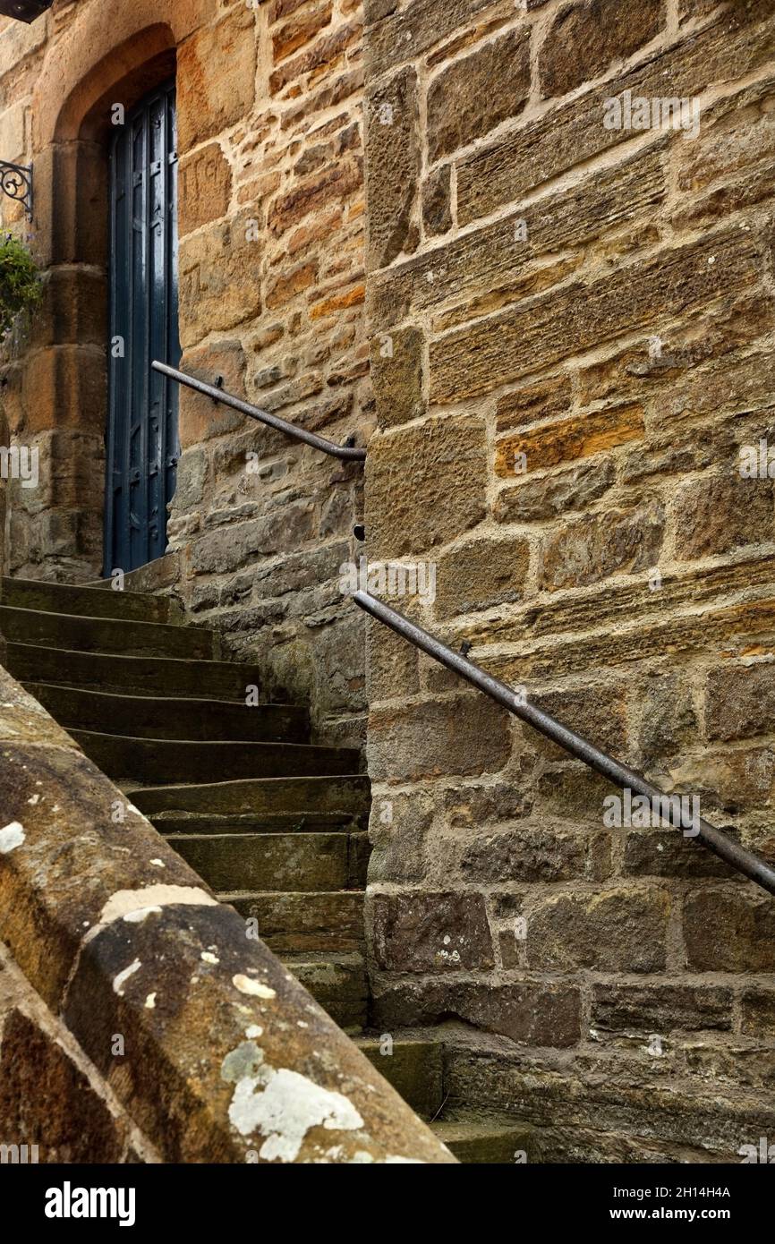Stone steps winding up the side of old building, Blanchland, Northumberland, UK.. Stock Photo