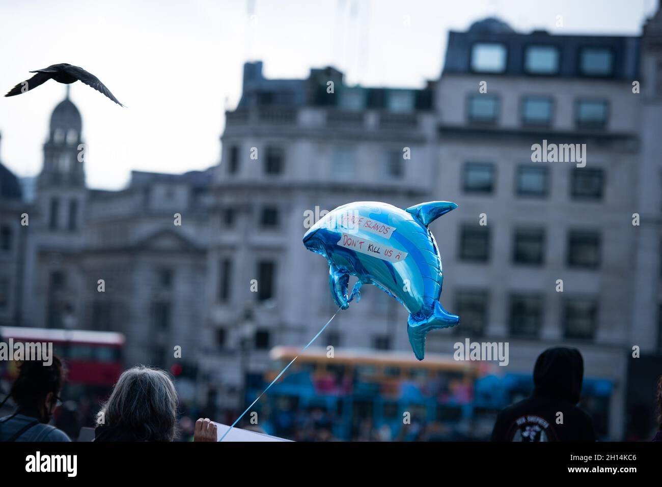 London, UK. 16th Oct, 2021. An activist holds a dolphin balloon during the Stop the Whale and Dolphin Slaughter Protest.Born Free's Policy Advisor Dominic Dyer calls for sanctions NOW to end the shameful Faroe Islands slaughter of whales and dolphins. The brutal slaughter of more than 1,400 white-sided dolphins in the Faroe Islands has triggered huge anger and revulsion around the world, and once again brought global attention to the long and bloody history of whale and dolphin-killing in this beautiful but isolated archipelago 200 miles north-west of Scotland. Credit: SOPA Images Limited/Alam Stock Photo