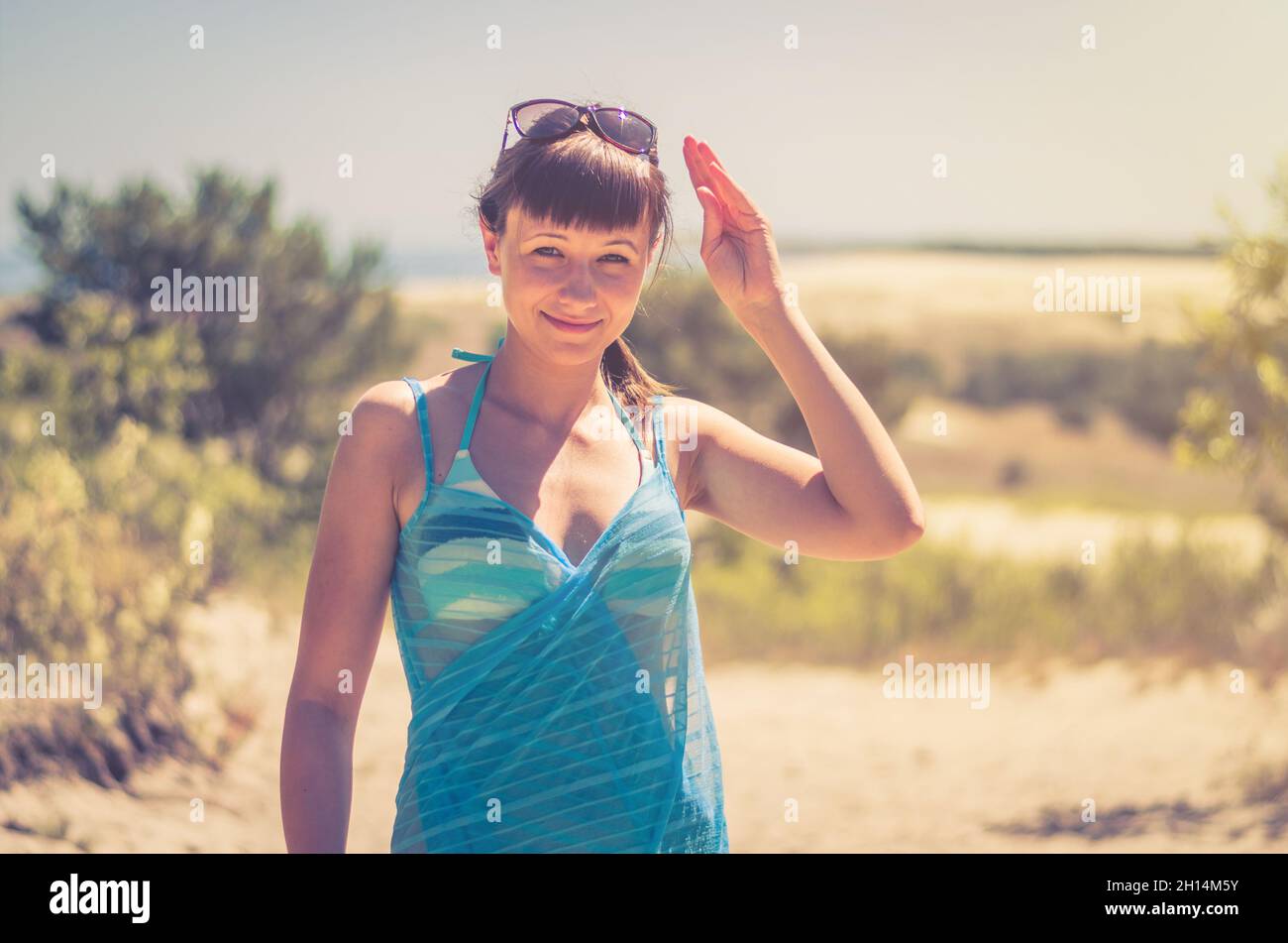Young beautiful girl in bikini, pareo wrap and sunglasses on head ...