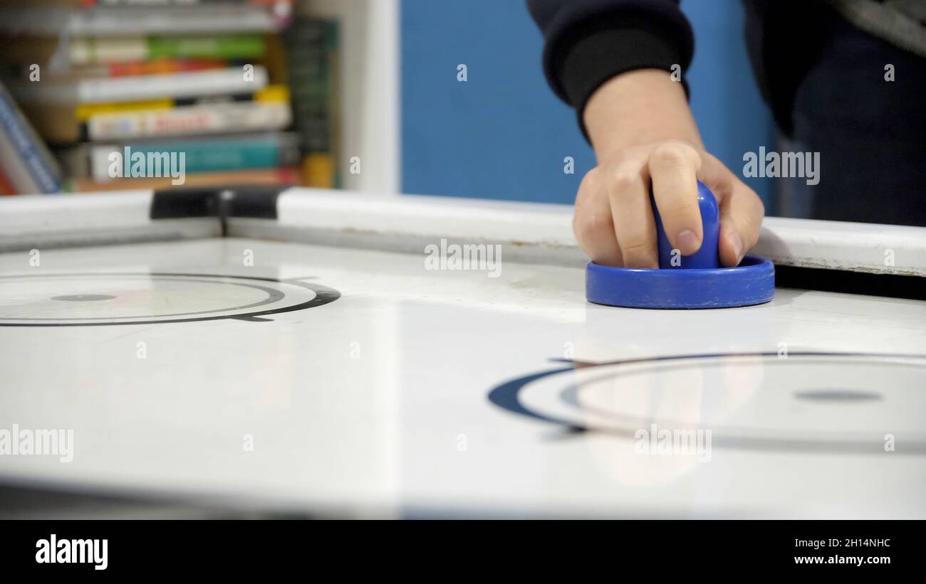 Air Hockey Game Playing in Arcade Close Up. Closeup hands of man
