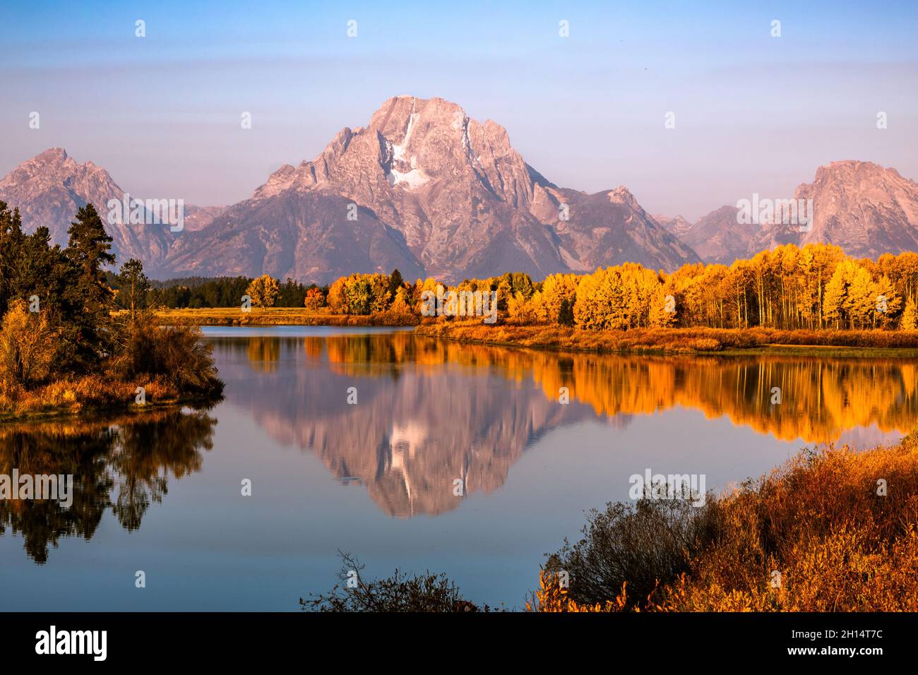 Fall colors on snake river with reflection of Mt Moran, Grand Teton