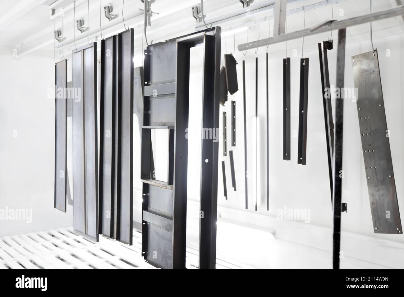 Factory metal surface coating paint in painting chamber. Powder coating