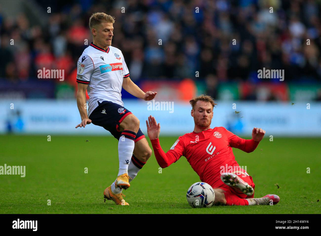 Lloyd Isgrove #23 of Bolton Wanderers is challenged by Tom Naylor #4 of Wigan Athletic Stock Photo