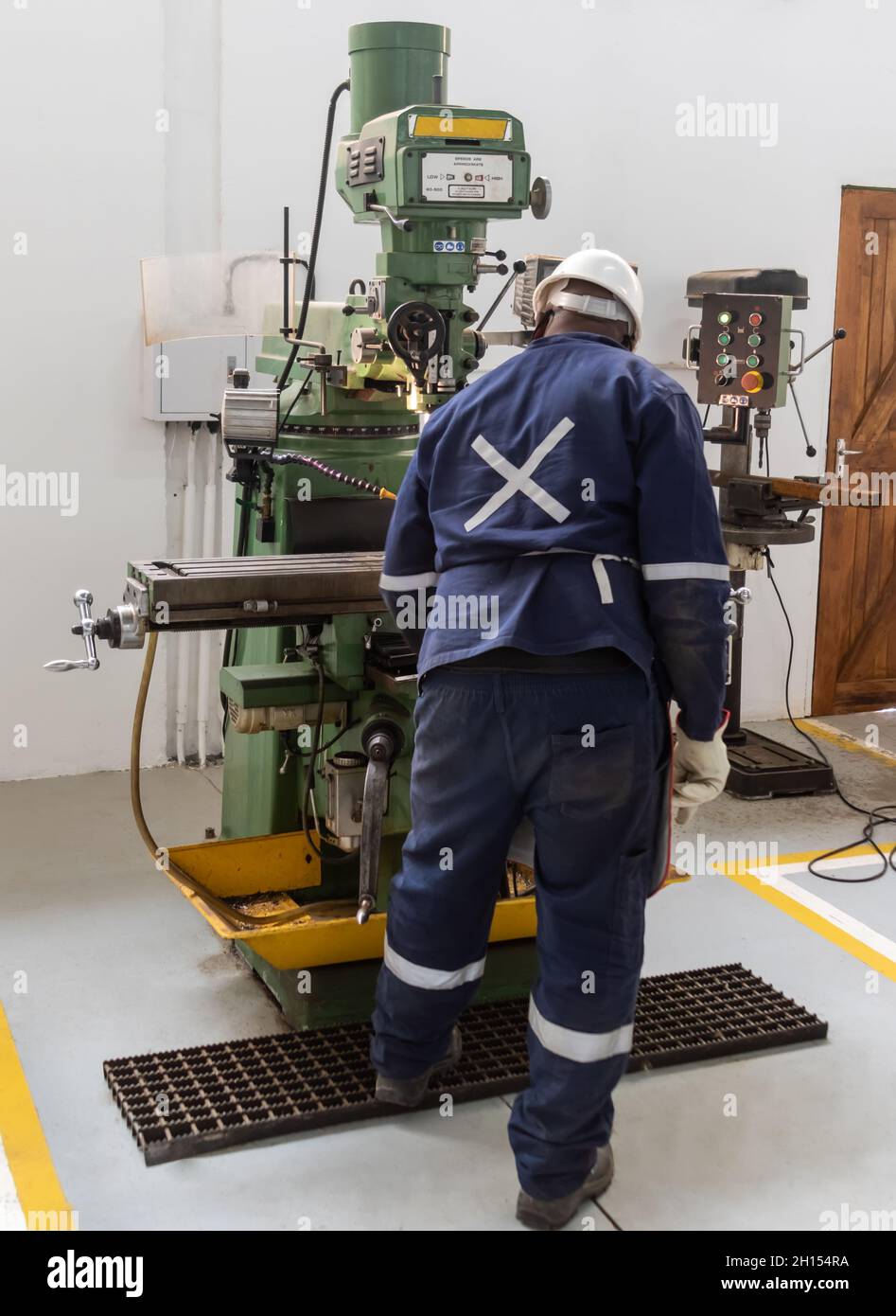 Motswana worker operating a milling machine in a Botswana workshop Stock Photo