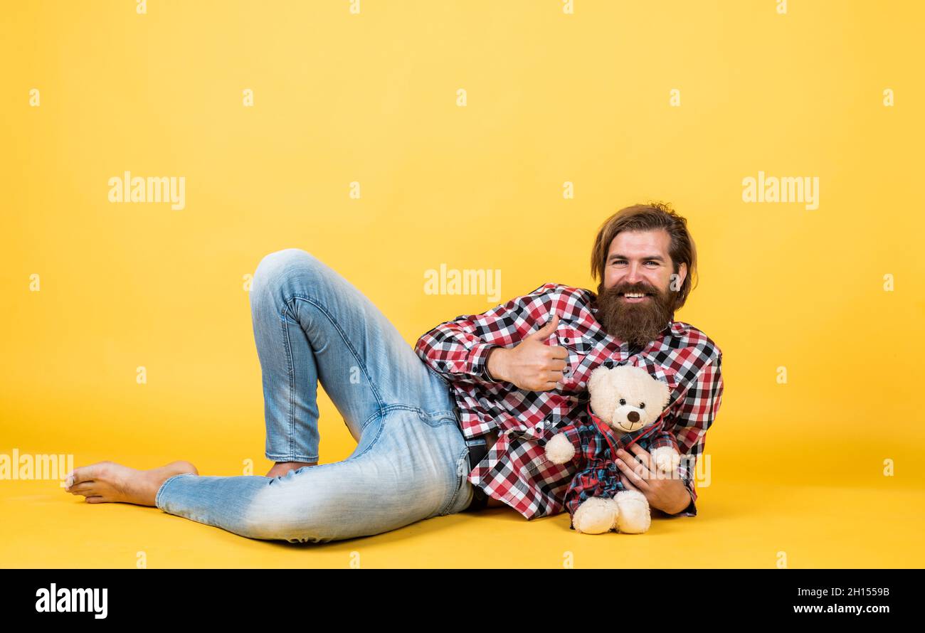 time to relax. happy birthday. being in good mood. happy valentines day. cheerful bearded man hold teddy bear. male feel playful with bear. brutal Stock Photo