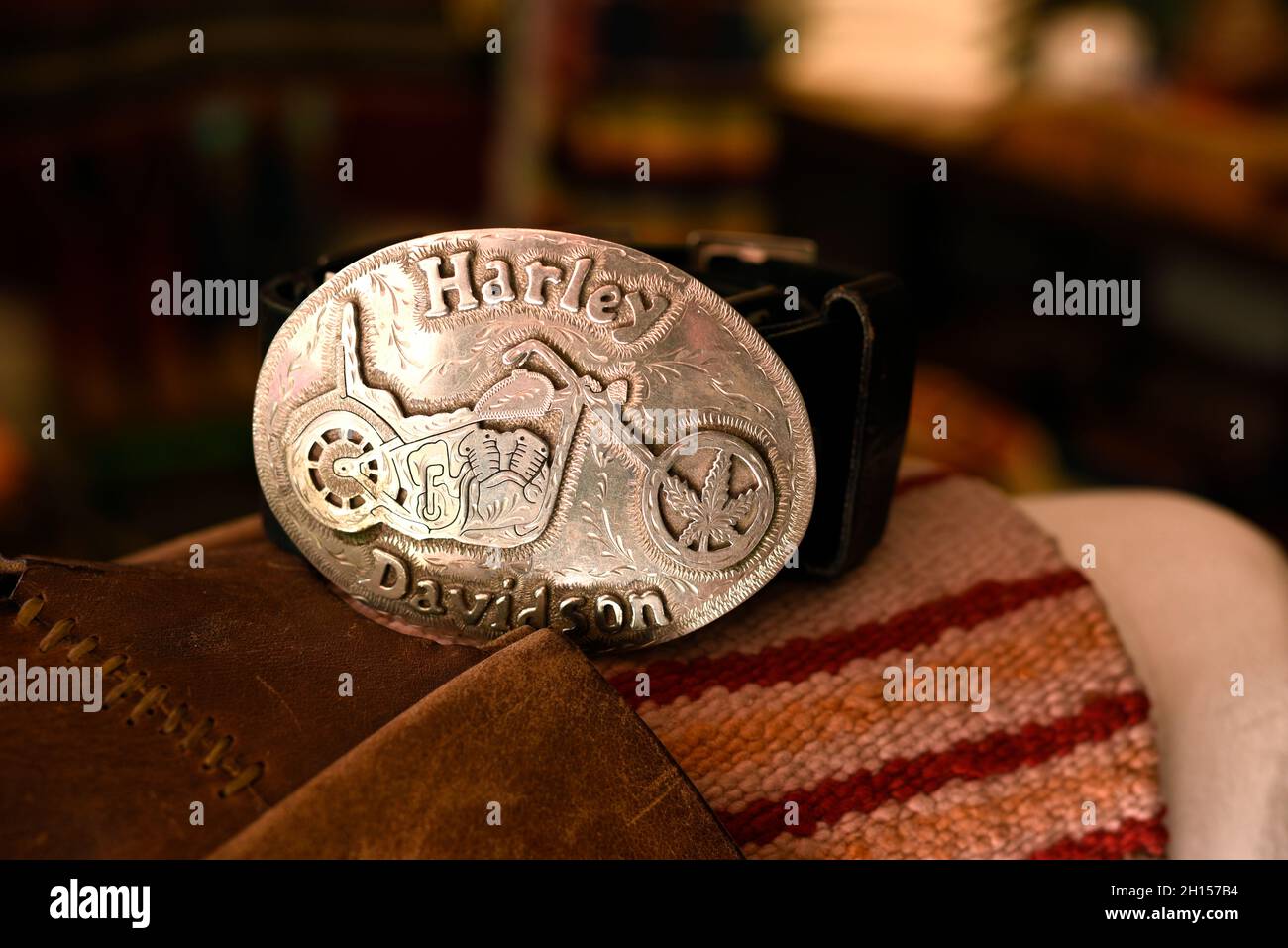 A custom made silver belt buckle engraved with a image of a Harley Davidson motorcycle Stock Photo Alamy
