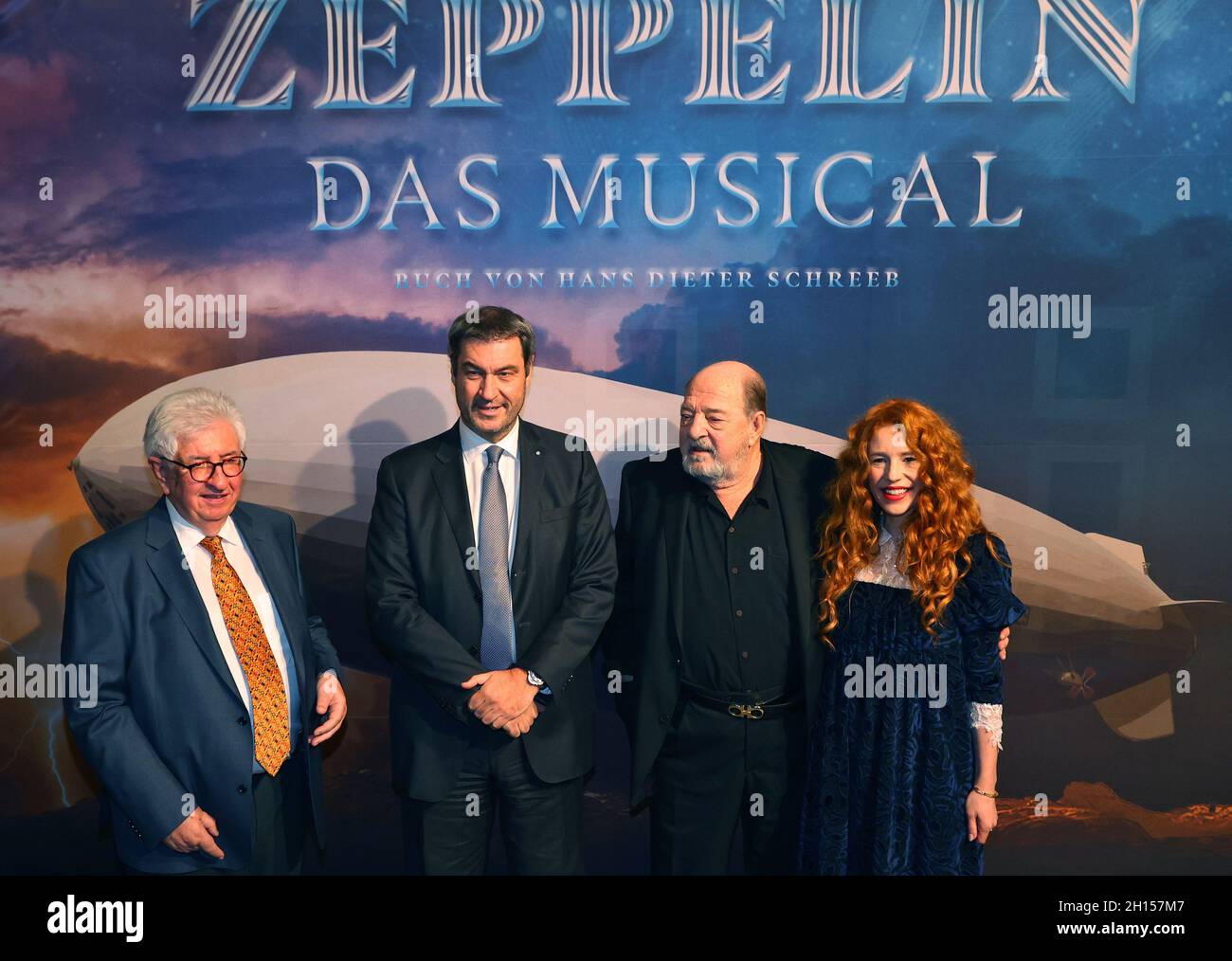 16 October 2021, Bavaria, Füssen: Hans Dieter Schreeb, author (l-r), Markus Söder, Bavarian Minister President and CSU Chairman, Ralph Siegel, composer and his wife Julia stand in front of photographers before the world premiere of the musical 'Zeppelin'. Photo: Karl-Josef Hildenbrand/dpa Stock Photo
