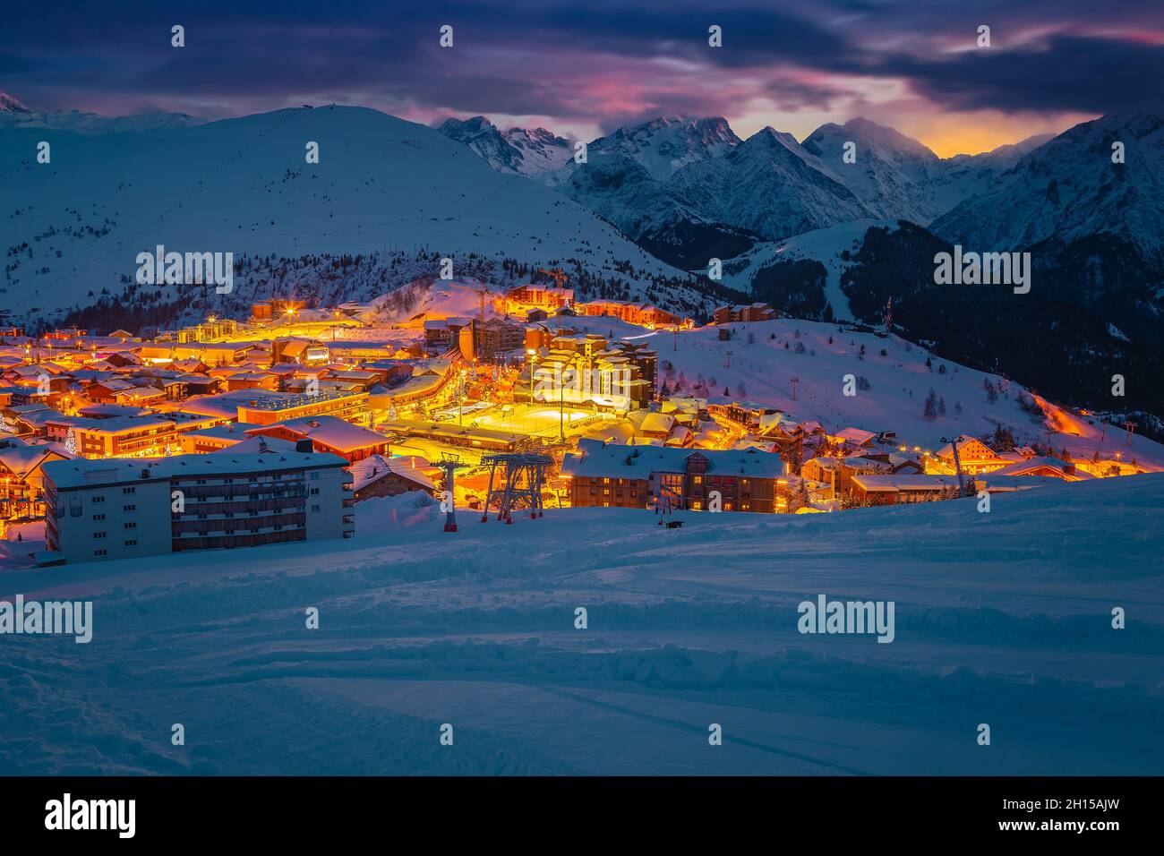 Great winter ski resort and cityscape at evening after sunset. One of the most beautiful winter travel destination, Alpe d Huez, Rhone Alps, France, E Stock Photo