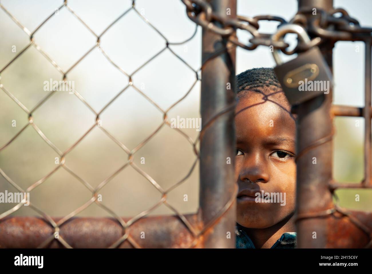 Portrait of locked African kid in the yard of the village in Botswana, rural area Stock Photo