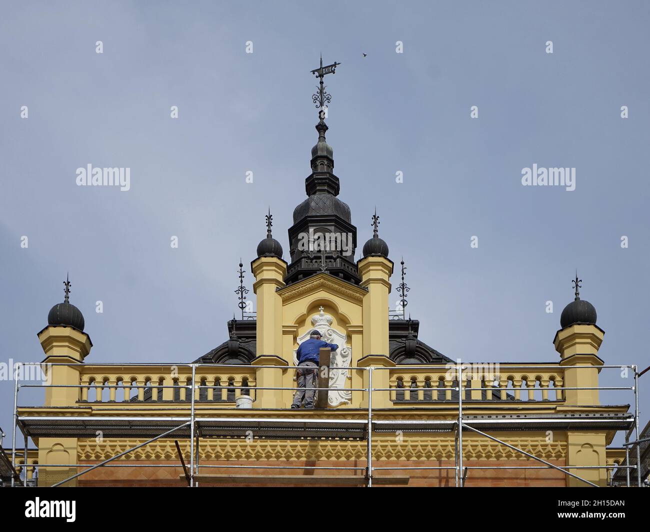 NOVI SAD, SERBIA - Mar 09, 2021: A Beautiful view of Bishop's palace during Restauration, with a worker on the scaffolding in Novi Sad, Serbia Stock Photo