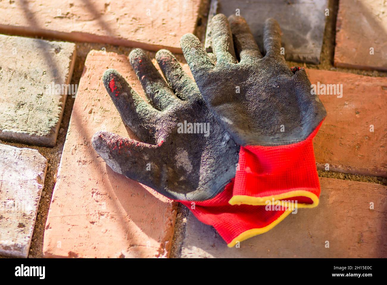 Used construction gloves thrown on the ground Stock Photo Alamy
