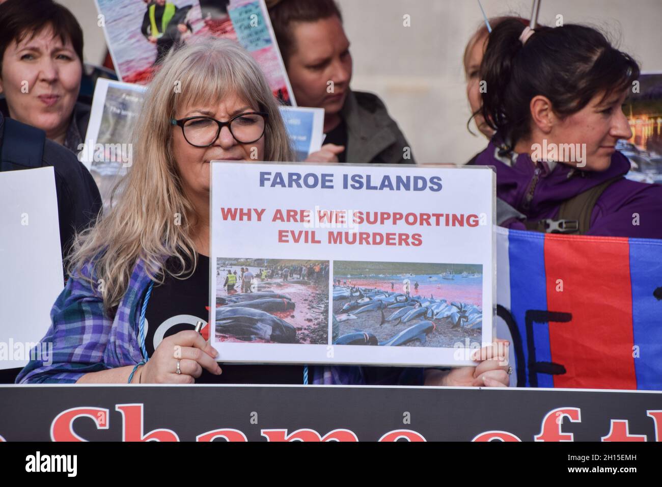 London, UK. 16th Oct, 2021. A protester holds a placard critical of the Faroe Islands during the demonstration in Trafalgar Square.Members of marine conservation organization Sea Shepherd and other activists marched through Westminster, calling for an end to the slaughter of dolphins in Faroe Islands and Taiji, Japan. Credit: SOPA Images Limited/Alamy Live News Stock Photo