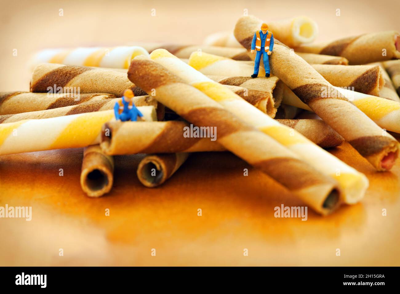conceptual workers working between wafer tube sticks Stock Photo