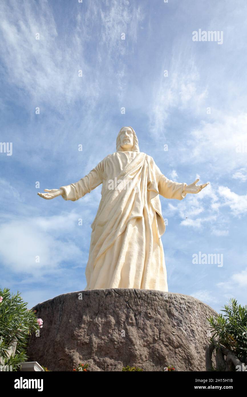 statue of christ the saviour at pilgrimage island , hundred islands national park. White statue against the sky. Stock Photo