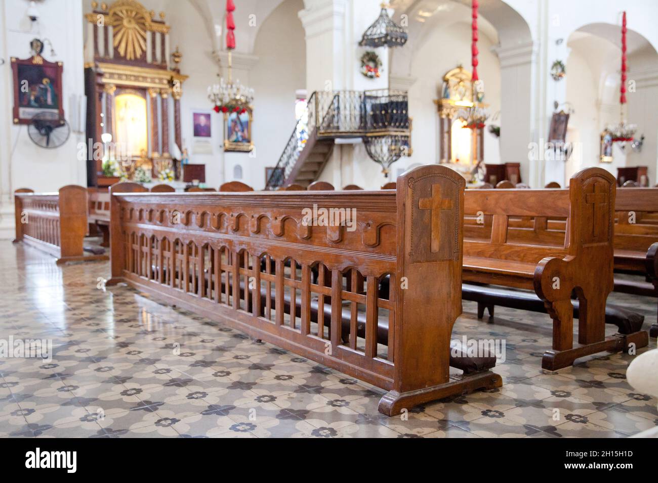 old wooden benches in the cathedral. The interior of the Philippine church. Stock Photo